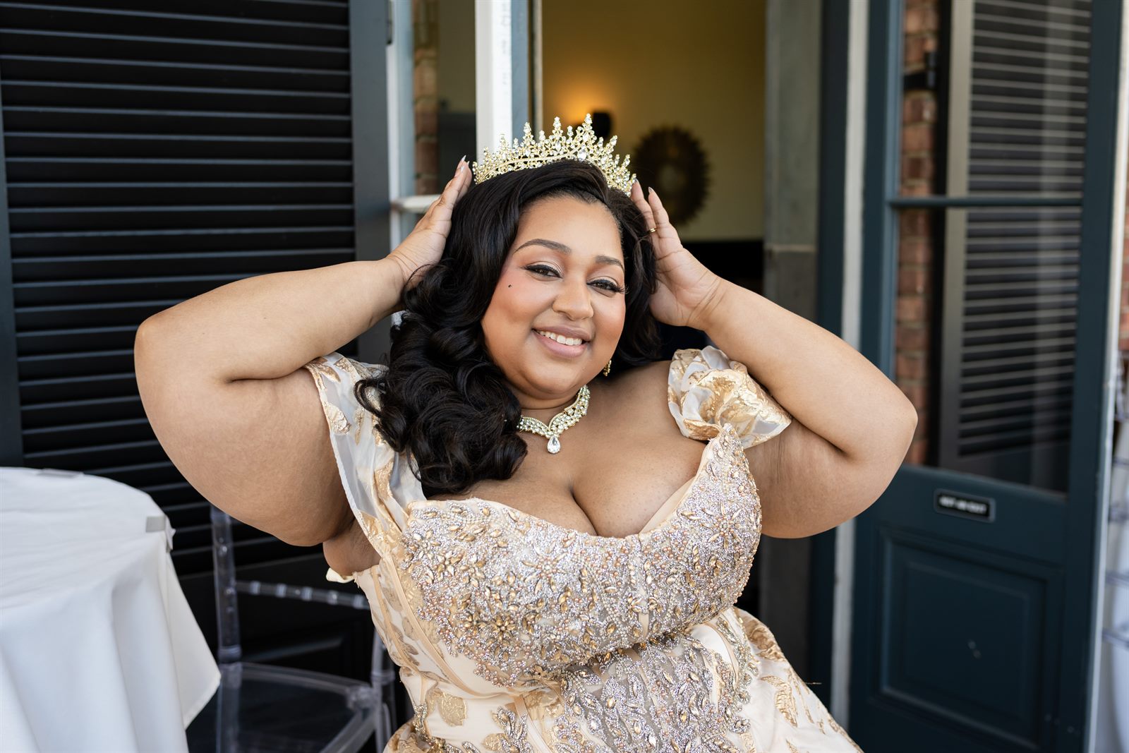 Bride playfully adjusting her crown while getting ready