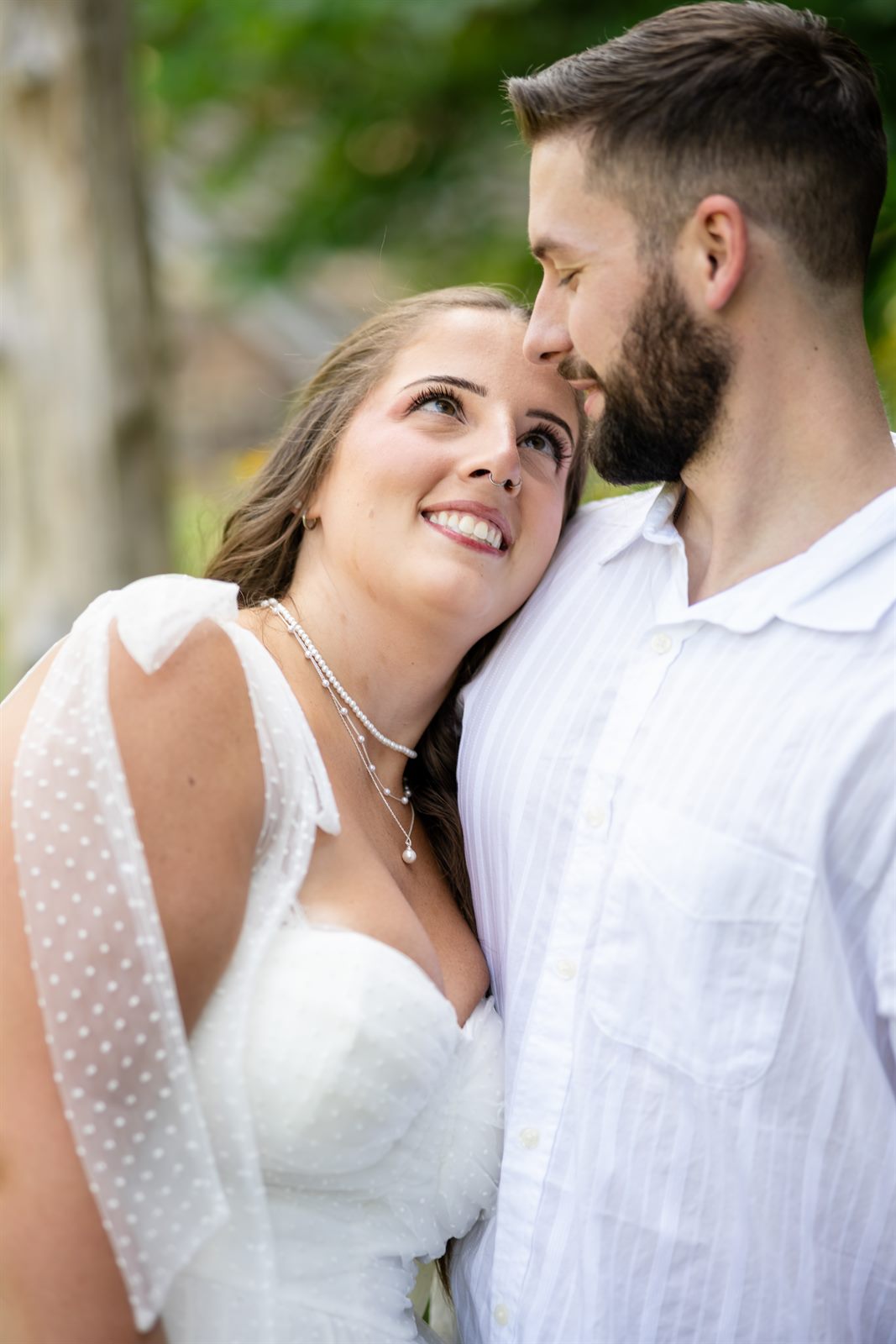 Engaged couple embracing during a relaxed outdoor engagement session