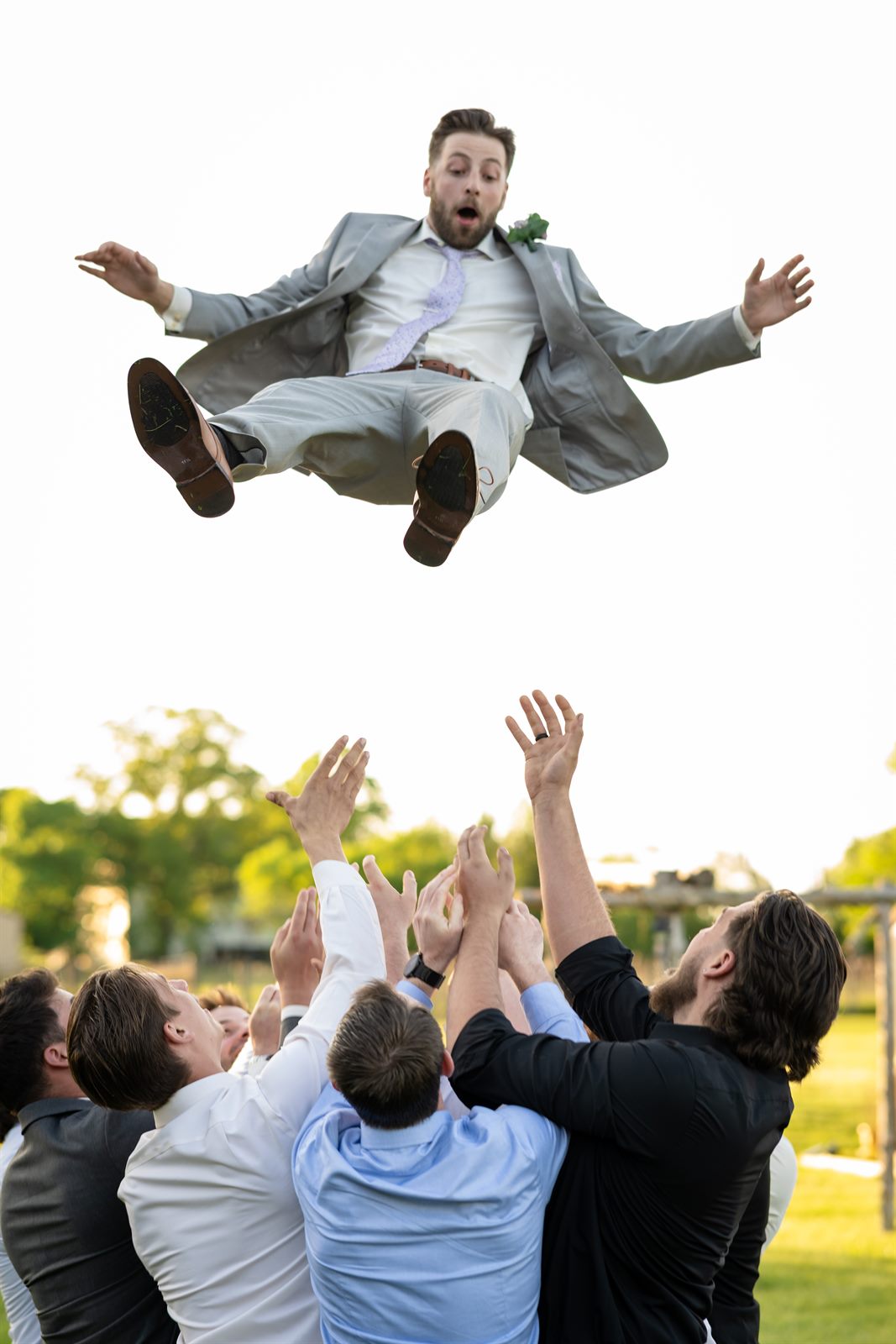 Groomsmen tossing the groom into the air at a Philadelphia wedding