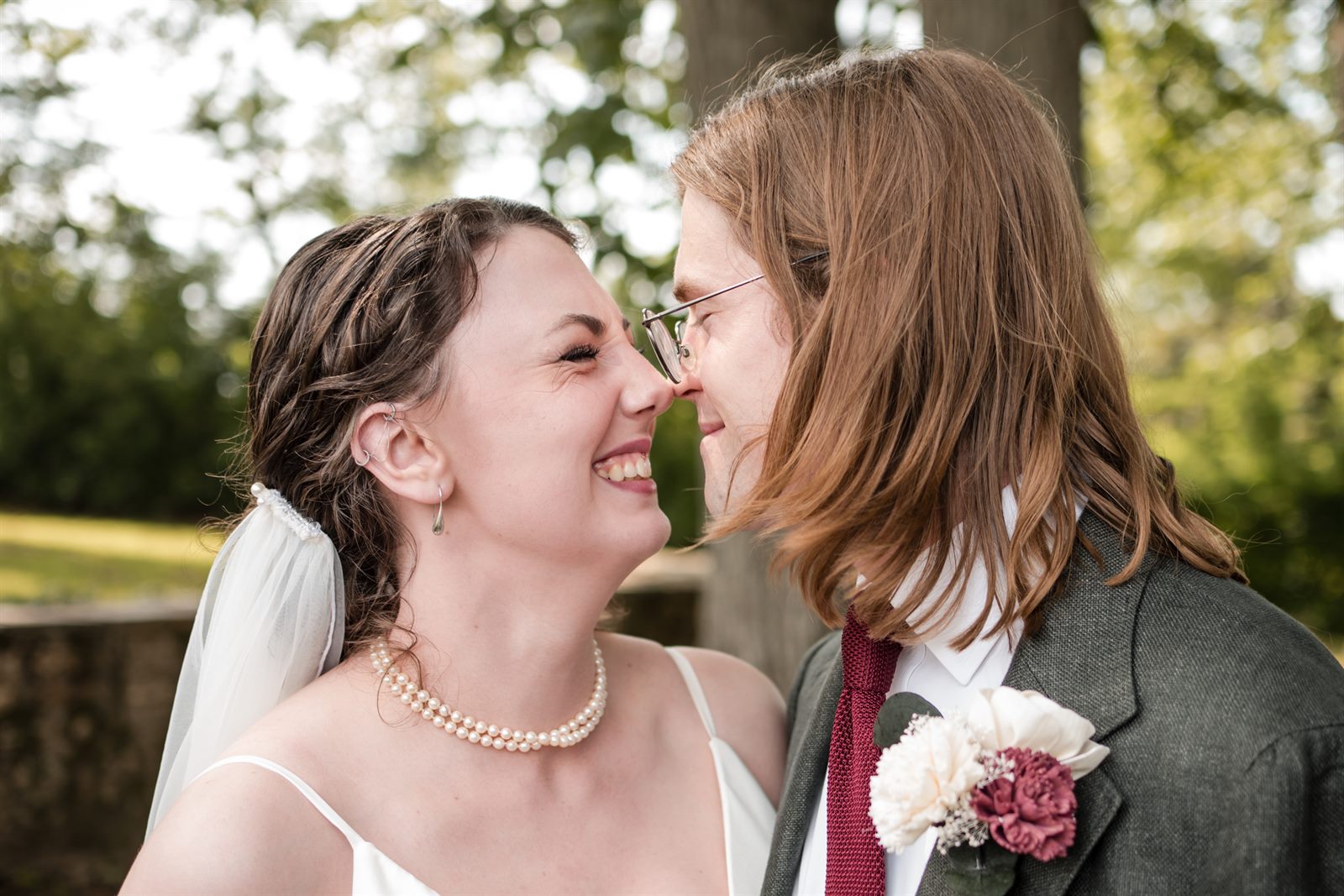 Bride and groom nose to nose laughing after their Philadelphia wedding ceremony